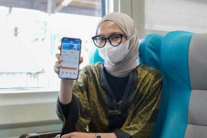 Penumpang kereta api menunjukkan aplikasi KAI Access di ponselnya (foto: istimewa)